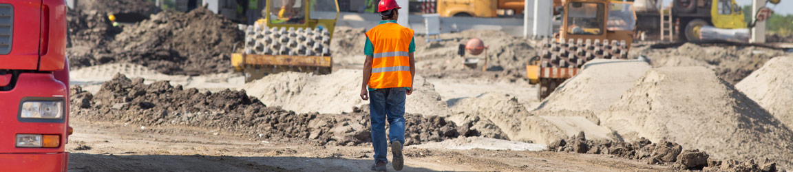 Construction worker walking on a worksite